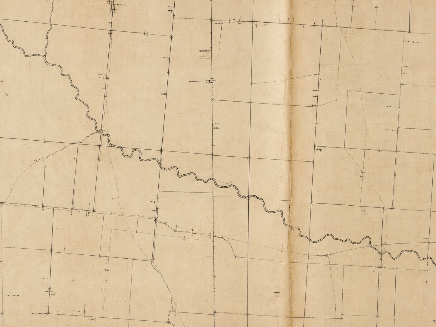 Archival parcel map with survey boundaries and a creek